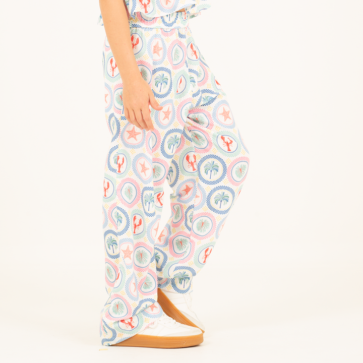PANTALÓN PARA NIÑA CON ESTAMPADO TROPICAL Y SILUETA AMPLIA