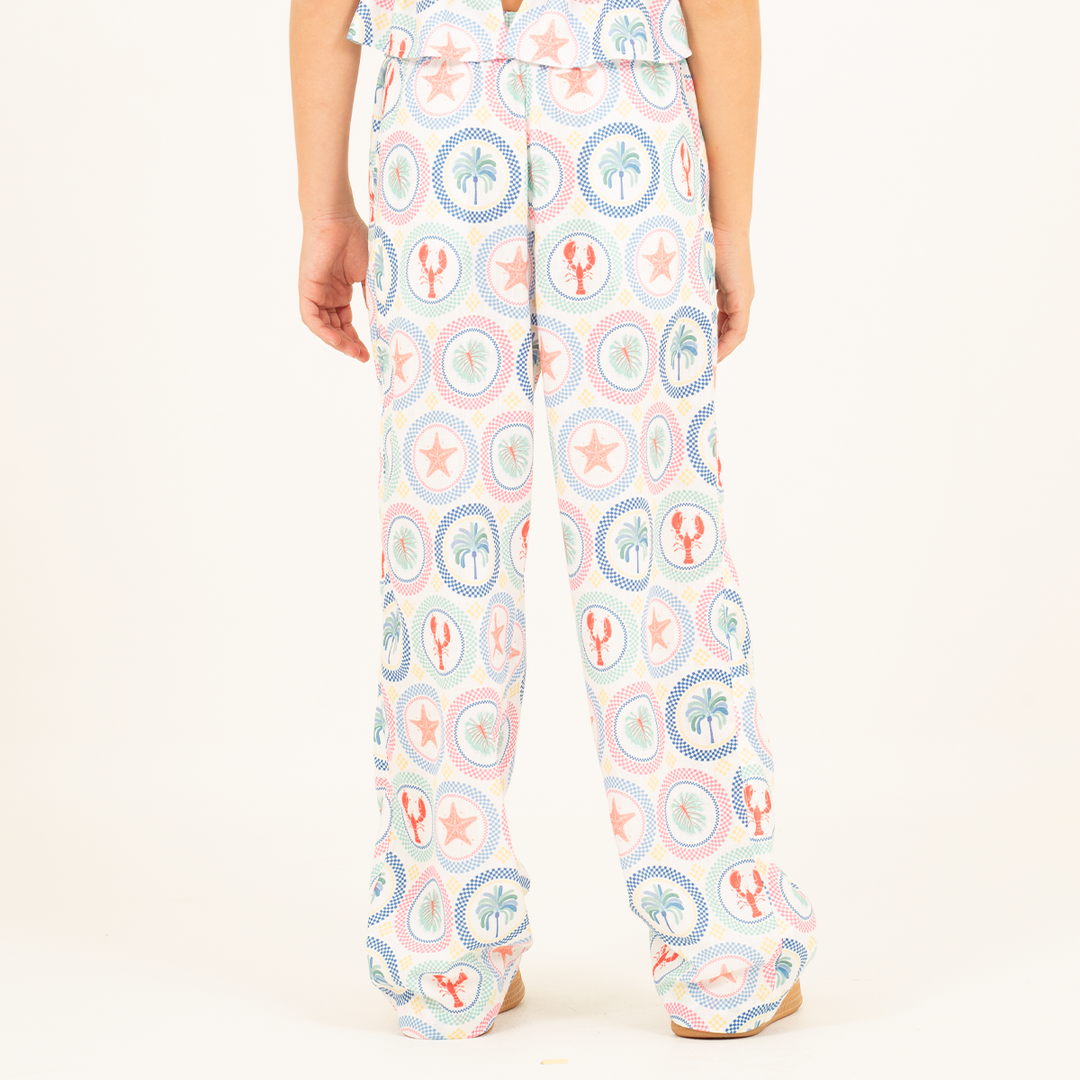 PANTALÓN PARA NIÑA CON ESTAMPADO TROPICAL Y SILUETA AMPLIA